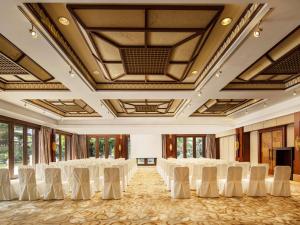 a room with a bunch of white chairs in it at Pullman Sanya Yalong Bay Villas & Resort in Sanya +217 photos