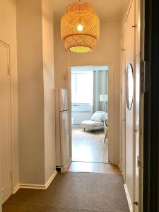 a kitchen with a refrigerator and a living room at Studio Brahe in Helsinki +3 photos