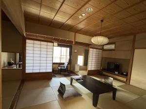 a living room with a table and chairs at Nunohan in Suwa