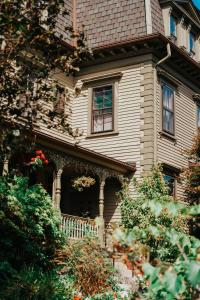 a large white house with a porch and windows at The Underwood-Hale House in Providence