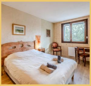 a bedroom with a large bed with two towels on it at Chez Isabelle & Urbain I T3 I Saint-Julien in Saint-Julien-en-Genevois