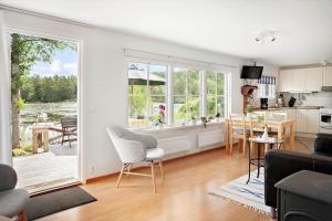a living room with a large window and a kitchen at SKA676-Immeln-Breanaes-3004 in Breanäs