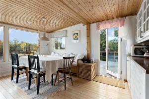a kitchen and dining room with a table and chairs at OST462-Oskarshamn-Kristineberg-Udden-10 in Oskarshamn