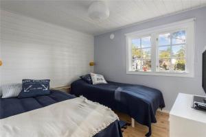 a bedroom with two beds and a window at OST462-Oskarshamn-Kristineberg-Udden-10 in Oskarshamn