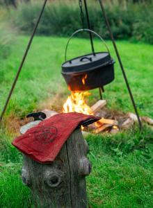 a pot on top of a wooden head with a fire at Wildlife Appartement - Wilderness Adventures Sweden in Bispgården