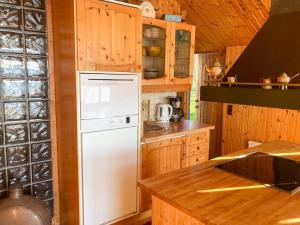 a kitchen with a white refrigerator and wooden cabinets at SKA712-Hoerby-Osby-Strandvaegen-120 in Osbyholm