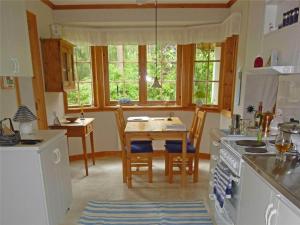 a kitchen with a table and a table and chairs at SKA445-Borrby-Tuvavaegen-19 in Sandby