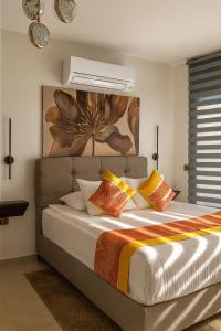 a bedroom with a large bed with colorful pillows at Elegant Ephesus Suites - Artemis in Selcuk +33 photos