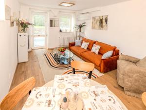 a living room with a couch and a table at Modern Apartment with Terrace -15 min to Airport, Free On-Site Parking in Prague +11 photos