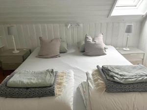 a large white bed in a room with a window at SKA711-Simrishamn-Lugnadalsvaegen-1 in Baskemölla