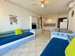 a kitchen with two beds in a room at Lovely flat with sunny terrace in Porto Santa Margherita di Caorle