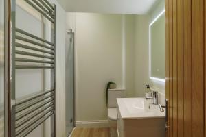 a white bathroom with a sink and a shower at Tyson Place, 2 bed Renovated Apartment, Ambleside in Ambleside +47 photos