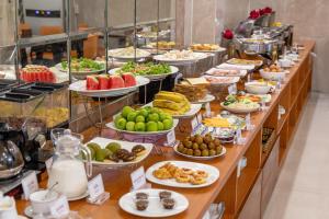 a buffet line with many plates of food at A25 Hotel - 274 Đề Thám in Ho Chi Minh City