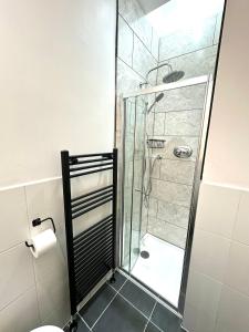a bathroom with a shower with a glass door at The Tay Residence, City Centre in Perth +4 photos