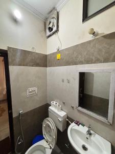 a small bathroom with a toilet and a sink at Ganga view by Bella Boho in Rishīkesh
