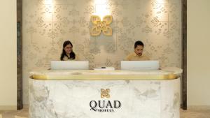 two people sitting at a counter with their laptops at Quad Hotels Hyderabad in Hyderabad