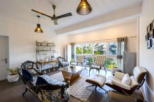 a living room with many chairs and a table at Samprati 3BR Villa with Balconies, Homecook & Pet Stay in Kasauli +25 photos