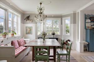 a dining room with a table and chairs and a chandelier at JON388-Stockaryd-Hetseryd in Södra Hetseryd