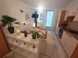 a small kitchen with a table in the middle of it at Studio La grotte Bohème in Lourdes