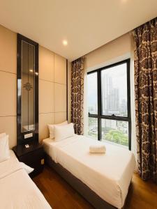 a hotel room with two beds and a window at Dorsett Residence KL in Kuala Lumpur