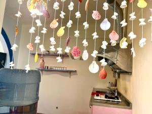 a bunch of paper mushrooms hanging from a kitchen ceiling at 海洋玫瑰海景民宿 in Eluan