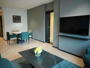 a living room with a large flat screen tv on a wall at Novotel Riyadh Al Anoud in Riyadh +92 photos