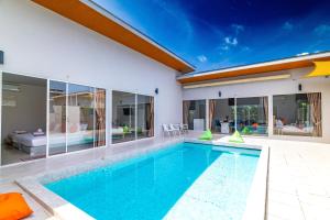 an indoor swimming pool in a house with glass walls at Andaman Sea Best Pool Access and Villas in Phuket Town