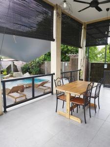 a wooden table and chairs on a patio at Lot 138 in Kota Bharu