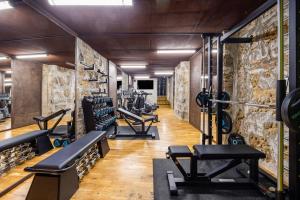 a gym with treadmills and machines in a room at PALAZZO SANTAMARINA Luxury Suite & Spa in Palermo