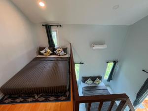 two bunk beds in a small room with two windows at Billabong Village in Ko Phangan