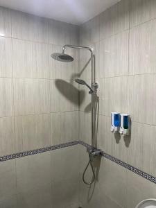 a shower in a bathroom with a shower head at Sekar Waru Homestay in Sanur +58 photos