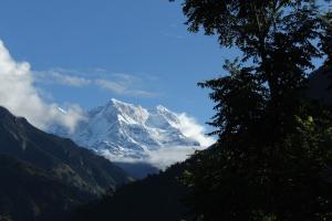 a snow covered mountain in the middle of a valley at Mount Holiday Pahadi Home Stay in Gupta Kāshi