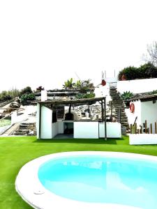 a swimming pool in the middle of a golf course at Ohana Villa Paula in Huertas del Palmar