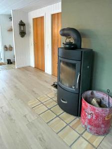a living room with a stove in a room at Hidden Gem By Thy National Park in Bedsted