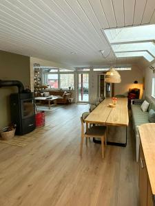 a living room with a table and a couch at Hidden Gem By Thy National Park in Bedsted