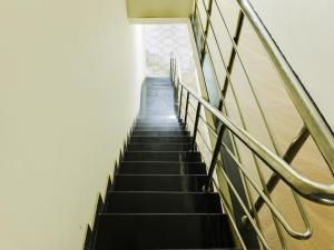 a stairway leading up to a building at Hotel O A K residency in Pīlamedu +26 photos