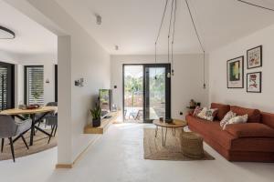 a living room with a couch and a table at Danube Cottage in Komárno