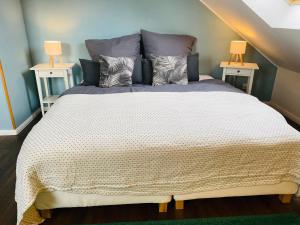 a bedroom with a large bed with two lamps at EinKlang - Familienidyll in Seesen +39 photos