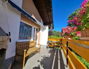 a porch with benches and flowers on a building at Apartmán Petra Cetnov in Cheb