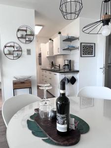 a bottle of wine sitting on a table in a kitchen at Edelstein am Meer in Damp +18 photos