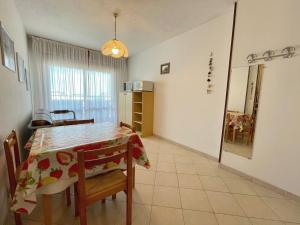 a kitchen and dining room with a table and chairs at Comfy flat for four-Beahost in Porto Santa Margherita di Caorle