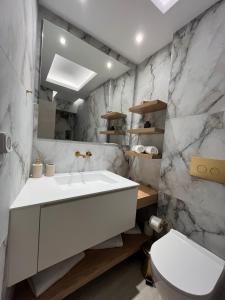 a bathroom with a white sink and a toilet at Casa De Sario in Rhodes Town +34 photos