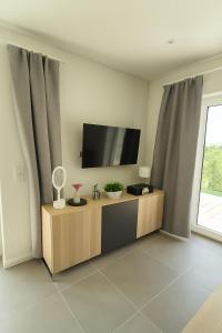 una sala de estar con un televisor de pantalla plana sobre un mueble en Fiete, en Westhof