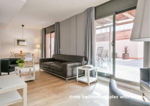 a living room with a couch and a table at Inside Barcelona Apartments Princep in Barcelona