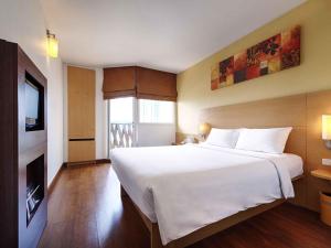 Ένα ή περισσότερα κρεβάτια σε δωμάτιο στο Ibis Pattaya