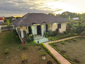 a small house with a thatched roof at Villa Nosy Be Madagascar in Dzamandzar