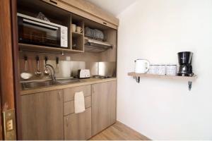 a kitchen with a sink and a microwave at Endless Blue House in Sami