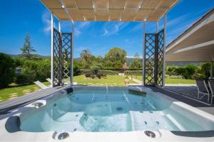a hot tub in the backyard of a house at Endless Blue House in Sami