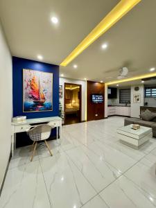 a large living room with a large painting on the wall at Lux Haven 2-Bedroom Apartment - Prime Location & Modern Comfort Near Gulberg in Lahore