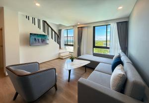 a living room with a couch and two chairs at Wyndham La Vita Rawai Phuket in Rawai Beach